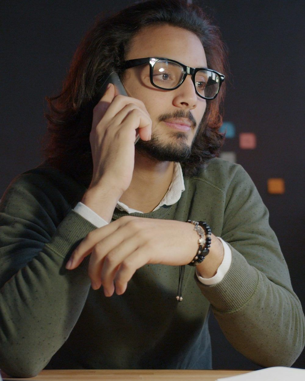 A salesperson on a headset call at a desk